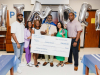 Representatives of the Kinder Foundation recognize teacher Joseph Stewart of Aldine ISD’s Plummer Middle School with the Kinder Excellence in Teaching Award.