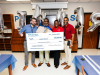 Representatives of the Kinder Foundation recognize teacher Joseph Stewart of Aldine ISD’s Plummer Middle School with the Kinder Excellence in Teaching Award.